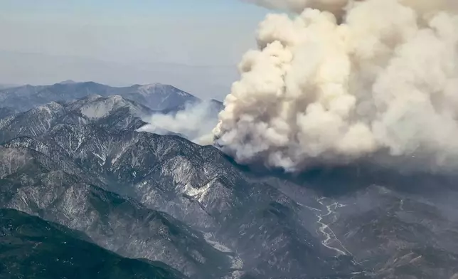 Smoke rises from the Vista fire as seen from a flight into Los Angeles International Airport on Tuesday, July 9, 2024, over Los Angeles. (AP Photo/Corinne Chin)