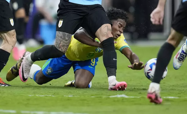 Brazil's Endrick is fouled by Uruguay's Mathias Olivera during a Copa America quarterfinal soccer match in Las Vegas, Saturday, July 6, 2024. (AP Photo/Godofredo A. Vásquez)