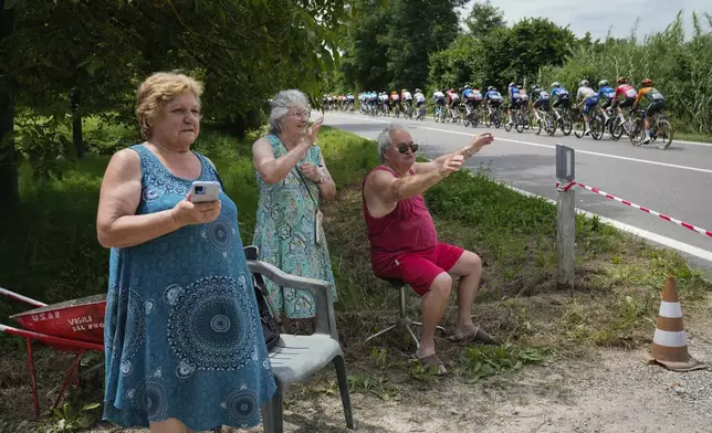 Spectators cheer as the riders pass during the third stage of the Tour de France cycling race over 230.8 kilometers (143.4 miles) with start in Piacenza and finish in Turin, Italy, Monday, July 1, 2024. (AP Photo/Jerome Delay)
