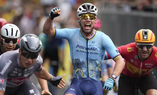 Britain's sprinter Mark Cavendish crosses the finish line to win a record 35th Tour de France stage win to break the record of Belgian legend Eddy Merckx in the fifth stage of the Tour de France cycling race over 177.4 kilometers (110.2 miles) with start in Saint-Jean-de-Maurienne and finish in Saint-Vulbas, France, Wednesday, July 3, 2024. (AP Photo/Daniel Cole)