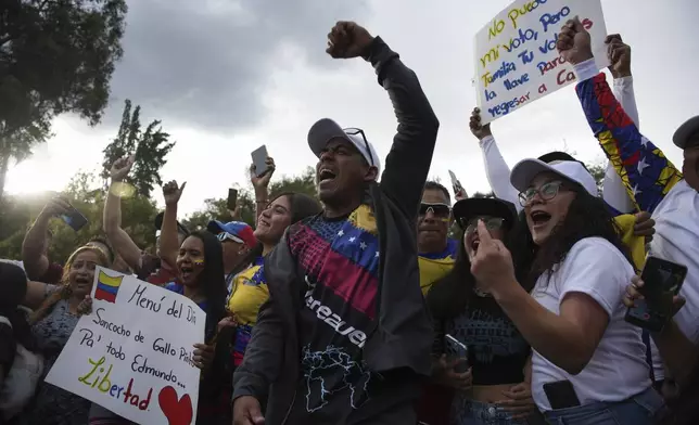 Venezuelan citizens chant "Freedom!" as they wait for the results of their nation's presidential election in Quito, Ecuador, Sunday, July 28, 2024. (AP Photo/Carlos Noriega)