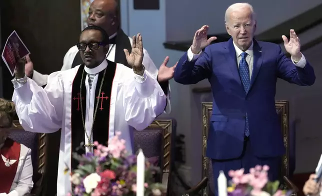 President Joe Biden, right, and pastor Dr. J. Louis Felton pray at a church service at Mt. Airy Church of God in Christ, Sunday, July 7, 2024, in Philadelphia. (AP Photo/Manuel Balce Ceneta)