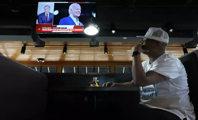 George Ledbetter watches news of President Joe Biden dropping out of the 2024 race for the White House at They Say Restaurant in Harper Woods, Mich., Sunday, July 21, 2024. (AP Photo/Paul Sancya)