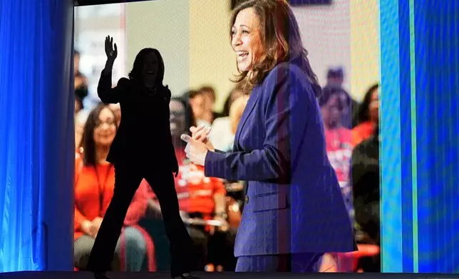 Vice President Kamala Harris, walking left, waves as she arrives to speak during the American Federation of Teachers' 88th national convention, Thursday, July 25, 2024, in Houston. (AP Photo/Tony Gutierrez)