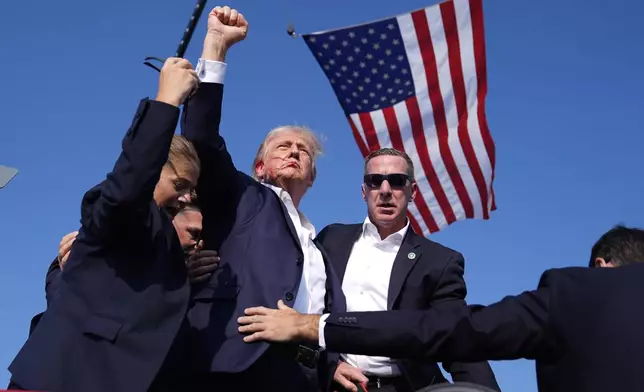 Republican presidential candidate former President Donald Trump is surrounded by U.S. Secret Service agents at a campaign rally, Saturday, July 13, 2024, in Butler, Pa. (AP Photo/Evan Vucci)