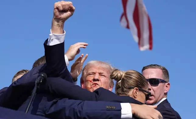 Republican presidential candidate former President Donald Trump is surrounded by U.S. Secret Service agents at a campaign rally, Saturday, July 13, 2024, in Butler, Pa. (AP Photo/Evan Vucci)