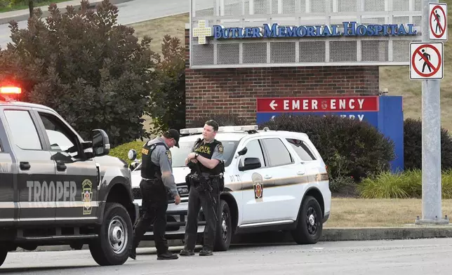 Pennsylvania State Troopers guard the entrance to Butler Memorial Hospital, Saturday, July 13, 2024, where Republican presidential candidate former President Donald Trump was said to be taken after shots were fired at a campaign rally in Butler, Pa. (AP Photo/Don Wright)