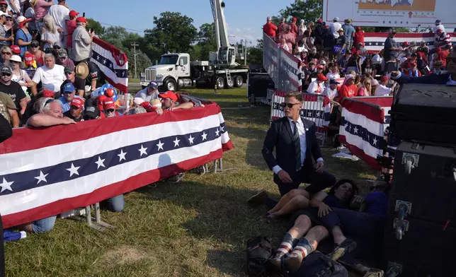 People react during a campaign rally with Republican presidential candidate former President Donald Trump at a campaign rally, Saturday, July 13, 2024, in Butler, Pa. (AP Photo/Evan Vucci)