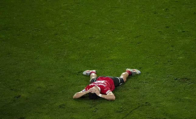 Austria's Christoph Baumgartner lays on the pitch after his team lose a round of sixteen match against Turkey 1-2 at the Euro 2024 soccer tournament in Leipzig, Germany, Tuesday, July 2, 2024. (AP Photo/Ebrahim Noroozi)