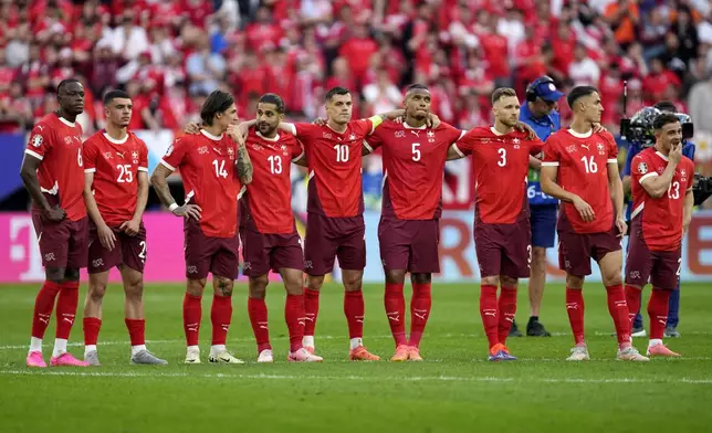 Switzerland players watch the penalty shootout during a quarterfinal match between England and Switzerland at the Euro 2024 soccer tournament in Duesseldorf, Germany, Saturday, July 6, 2024. (AP Photo/Darko Vojinovic)