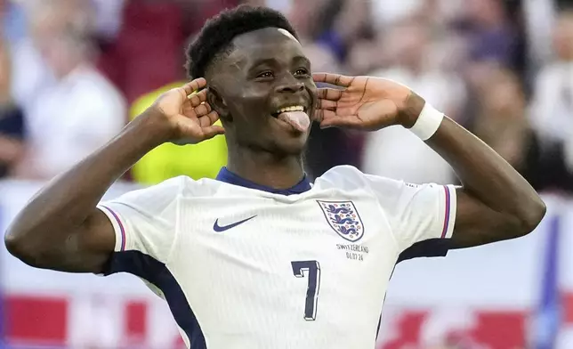 England's Bukayo Saka reacts after scoring by penalty during a quarterfinal match between England and Switzerland at the Euro 2024 soccer tournament in Duesseldorf, Germany, Saturday, July 6, 2024. (AP Photo/Darko Vojinovic)