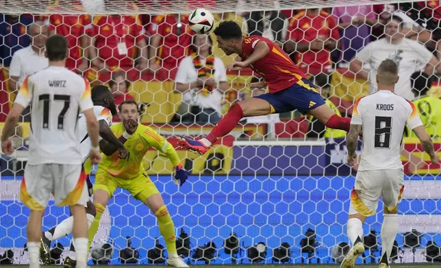 Spain's Mikel Merino, centre, scores his side's second goal during a quarter final match between Germany and Spain at the Euro 2024 soccer tournament in Stuttgart, Germany, Friday, July 5, 2024. (AP Photo/Ariel Schalit)