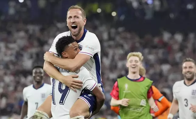 England's Harry Kane celebrates in the arms of teammate Ollie Watkins at the end of a semifinal match between the Netherlands and England at the Euro 2024 soccer tournament in Dortmund, Germany, Wednesday, July 10, 2024. England won 2-1. (AP Photo/Martin Meissner)