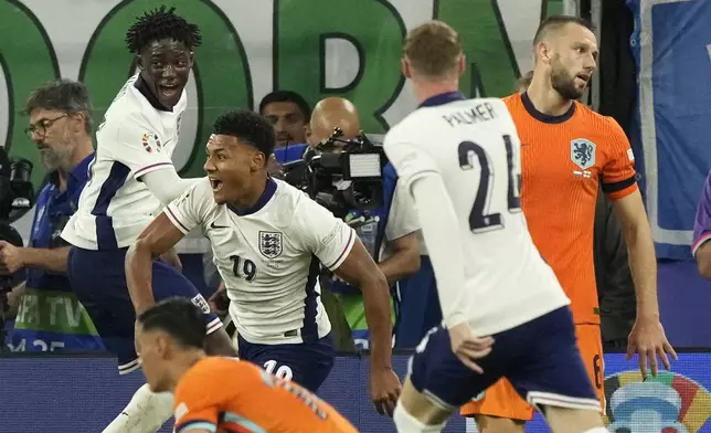 England's Ollie Watkins, center, celebrates after scoring his sides second goal during a semifinal match between the Netherlands and England at the Euro 2024 soccer tournament in Dortmund, Germany, Wednesday, July 10, 2024. (AP Photo/Frank Augstein)