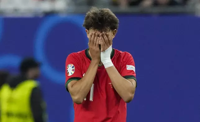 Portugal's Joao Felix reacts at the end of extra time during a quarter final match between Portugal and France at the Euro 2024 soccer tournament in Hamburg, Germany, Friday, July 5, 2024. (AP Photo/Frank Augstein)