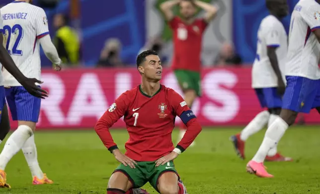 Portugal's Cristiano Ronaldo reacts after failing to score during a quarter final match between Portugal and France at the Euro 2024 soccer tournament in Hamburg, Germany, Friday, July 5, 2024. (AP Photo/Martin Meissner)