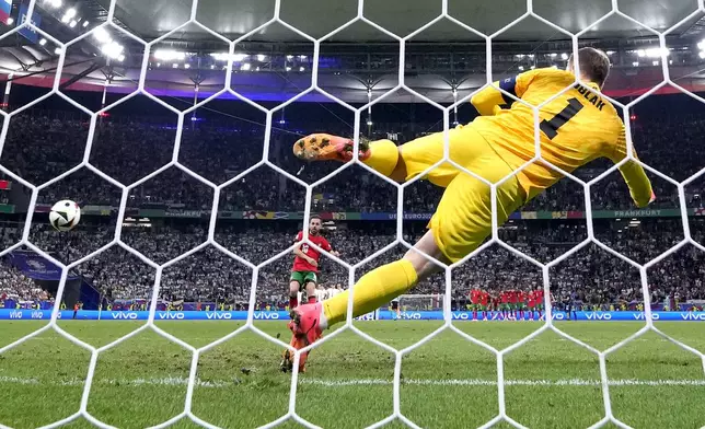 Portugal's Bernardo Silva scores the decisive penalty goal during a round of sixteen match between Portugal and Slovenia at the Euro 2024 soccer tournament in Frankfurt, Germany, Monday, July 1, 2024. (AP Photo/Matthias Schrader)