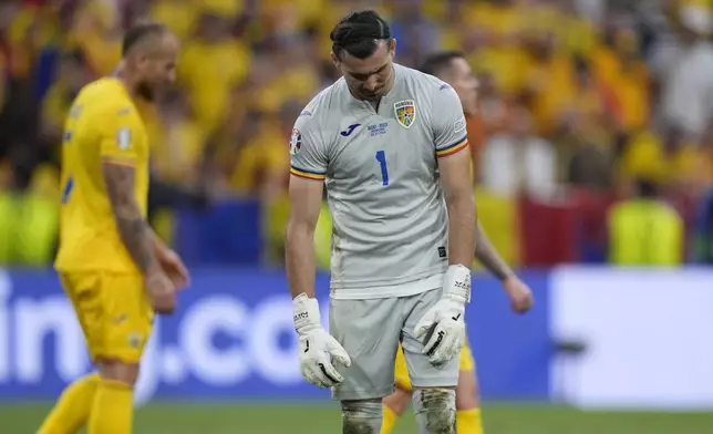 Romania's goalkeeper Florin Nita reacts after Donyell Malen of the Netherlands scored his side's third goal during a round of sixteen match between Romania and the Netherlands at the Euro 2024 soccer tournament in Munich, Germany, Tuesday, July 2, 2024. (AP Photo/Matthias Schrader)