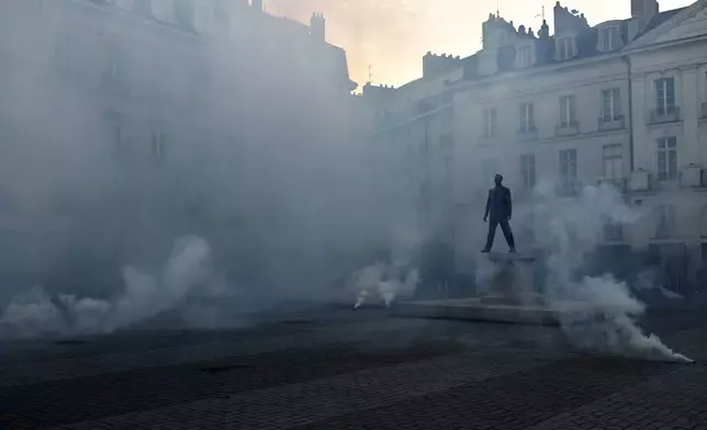 Demonstrators set off smoke flares as they react to projected results after the second round of the legislative elections, Sunday, July 7, 2024 in Nantes, western France. Polls have closed in France, and polling projections say a coalition on the left that came together unexpectedly has won the most parliamentary seats in the pivotal runoff elections after a high turnout among voters. (AP Photo/Jeremias Gonzalez)