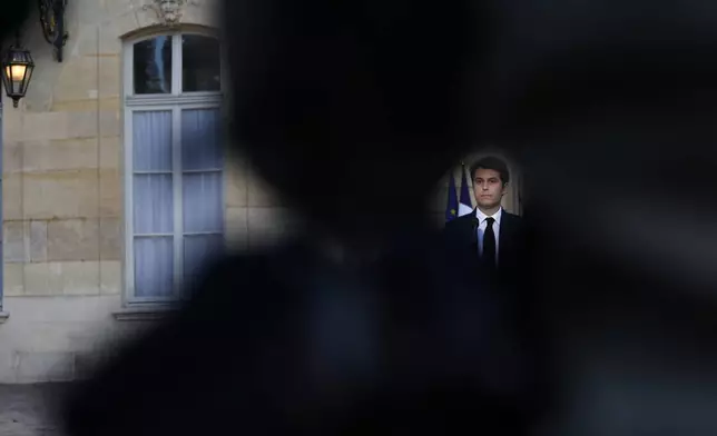 French Prime Minister Gabriel Attal delivers a speech after the second round of the legislative elections, Sunday, July 7, 2024 in Paris. A coalition of the French left that quickly banded together to beat a surging far right in legislative elections won the most seats in parliament but not a majority, according to polling projections Sunday, a stunning outcome that threatens to plunge the country into political and economic turmoil. (AP Photo/Aurelien Morissard)