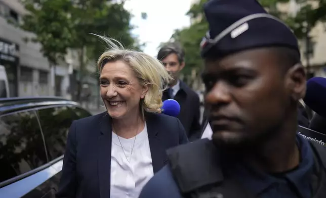 Far-right leader Marine Le Pen arrives at the National Rally party headquarters, Thursday, July 4, 2024 in Paris. The National Rally secured the most votes in the first round of the early legislative elections on June 30 but not enough to claim an overall victory that would allow the formation of France's first far-right government since World War II. (AP Photo/Thibault Camus)