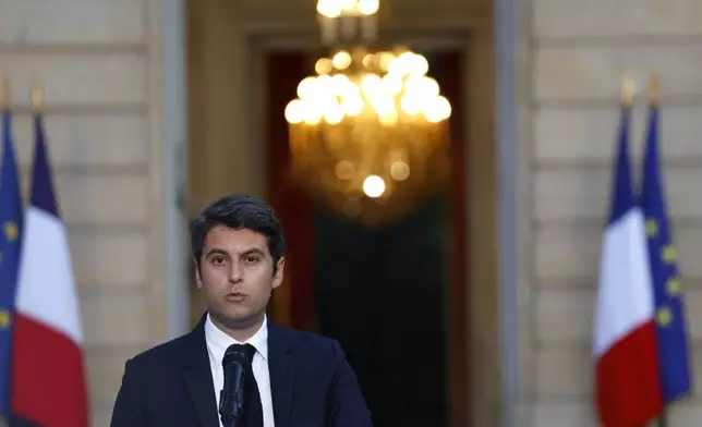 French Prime Minister Gabriel Attal delivers a speech after the second round of the legislative elections, Sunday, July 7, 2024, in Paris. A coalition of the French left that quickly banded together to beat a surging far right in legislative elections won the most seats in parliament but not a majority, according to polling projections Sunday, a stunning outcome that threatens to plunge the country into political and economic turmoil. (AP Photo/Aurelien Morissard)