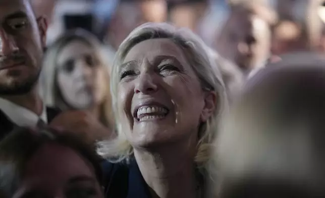 French far right leader Marine Le Pen reacts as she meets supporters and journalists after the release of projections based on the actual vote count in select constituencies , Sunday, June 30, 2024 in Henin-Beaumont, northern France. French voters propelled the far-right National Rally to a strong lead in first-round legislative elections Sunday and plunged the country into political uncertainty, according to polling projections. (AP Photo/Thibault Camus)