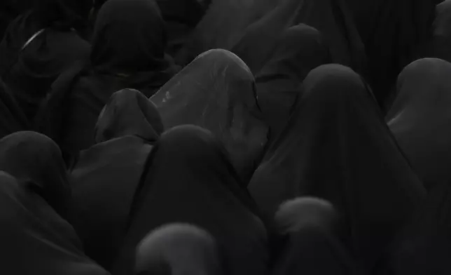 Chador-clad Shiite Muslim women mourn during Ashoura ritual, commemorating the 7th century martyrdom of Prophet Muhammad's grandson, Hussein, in the battle of Karbala in present-day Iraq, at the old main bazaar of Tehran, Iran, Tuesday, July 16, 2024. Shiites represent over 10% of the world's 1.8 billion Muslims and view Hussein as the rightful successor to the Prophet Muhammad. (AP Photo/Vahid Salemi)