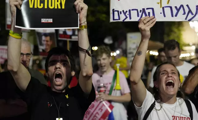 Holding signs with photos of Israeli hostages and demanding their release, people react as they watch Prime Minister Benjamin Netanyahu's speech before the U.S. Congress, Wednesday, July 24, 2024, in Tel Aviv, Israel. (AP Photo/Ariel Schalit)