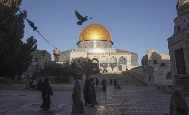 FILE - Muslims walk next to the Dome of Rock Mosque at the Al-Aqsa Mosque compound in Jerusalem's Old City, March 10, 2024. Israeli lawmaker Itamar Ben-Gvir visited Al-Aqsa Mosque compound Thursday, July 18, 2024, a move that could threaten the delicate Gaza cease-fire talks. (AP Photo/Mahmoud Illean, File)