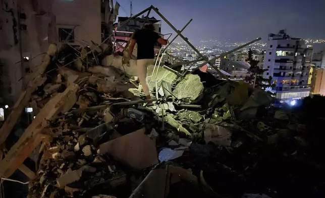 A man inspects a destroyed building that was hit by an Israeli airstrike in the southern suburbs of Beirut, Lebanon, Tuesday, July 30, 2024. An Israeli airstrike hit Hezbollah's stronghold south of Beirut Tuesday evening causing damage, a Hezbollah official and the group's TV station said. (AP Photo/Hussein Malla)