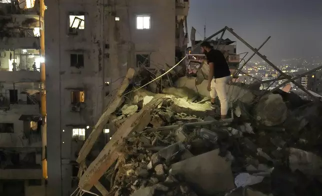 A man inspects a destroyed building that was hit by an Israeli airstrike in the southern suburbs of Beirut, Lebanon, Tuesday, July 30, 2024. An Israeli airstrike hit Hezbollah's stronghold south of Beirut Tuesday evening causing damage, a Hezbollah official and the group's TV station said. (AP Photo/Hussein Malla)