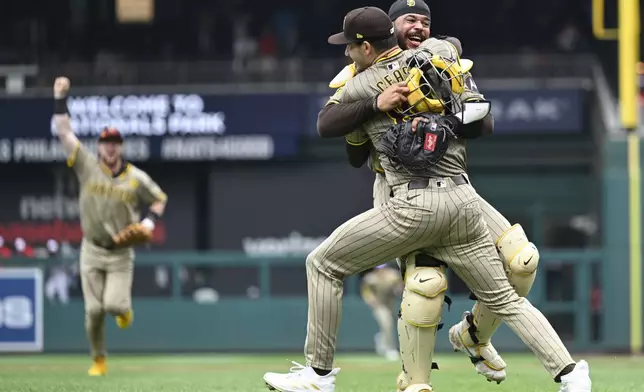 San Diego Padres starting pitcher Dylan Cease, center, celebrates his no-hitter with catcher Luis Campusano after the ninth inning of a baseball game against the Washington Nationals, Thursday, July 25, 2024, in Washington. (AP Photo/John McDonnell)