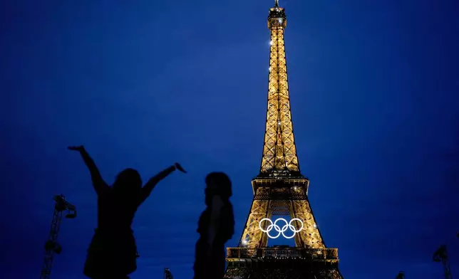 The United States' Amarilees Bolorin, left, takes a selfie with a friend in front of the Eiffel Tower ahead of the 2024 Summer Olympics, Thursday, July 25, 2024, in Paris, France. (AP Photo/Natacha Pisarenko)