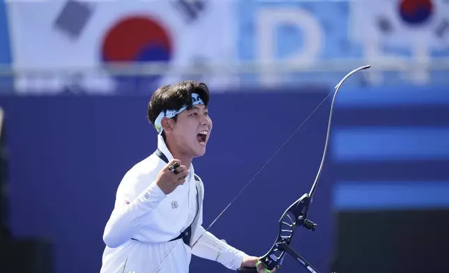 South Korea's Wooseok Lee celebrates winning during the men's team semifinals Archery competition against China at the 2024 Summer Olympics, Monday, July 29, 2024, in Paris, France. (AP Photo/Rebecca Blackwell)