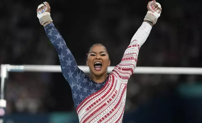 Jordan Chiles, of the United States, celebrates after performing on the uneven bars during the women's artistic gymnastics team finals round at Bercy Arena at the 2024 Summer Olympics, Tuesday, July 30, 2024, in Paris, France. (AP Photo/Natacha Pisarenko)