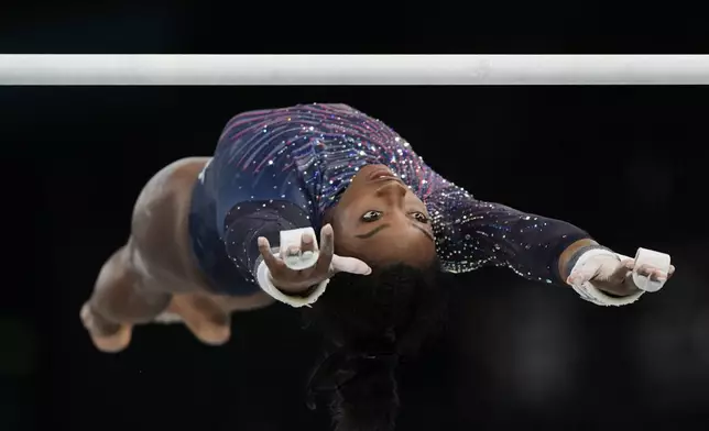 Simone Biles of the United States practices the uneven bars during a gymnastics training session at Bercy Arena at the 2024 Summer Olympics, Thursday, July 25, 2024, in Paris, France. (AP Photo/Francisco Seco)