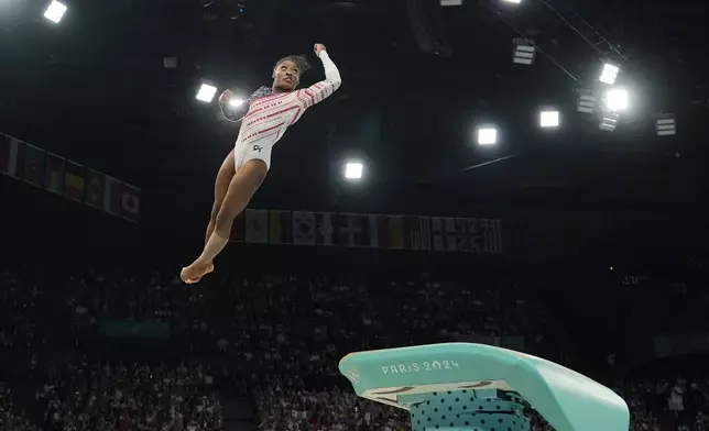 Simone Biles, of the United States, performs on the vault during the women's artistic gymnastics team finals round at Bercy Arena at the 2024 Summer Olympics, Tuesday, July 30, 2024, in Paris, France. (AP Photo/Charlie Riedel)