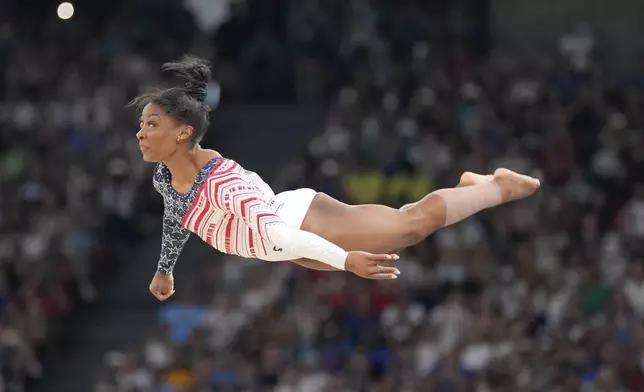 Simone Biles, of the United States, performs on the floor during the women's artistic gymnastics team finals round at Bercy Arena at the 2024 Summer Olympics, Tuesday, July 30, 2024, in Paris, France. (AP Photo/Charlie Riedel)