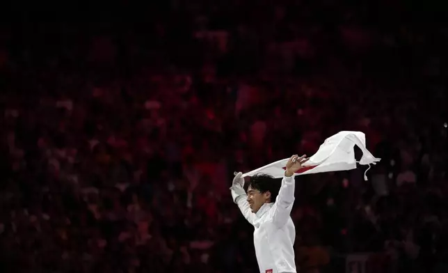 Japan's Koki Kano celebrates after winning the men's individual Epee final match against France's Yannik Borel during the 2024 Summer Olympics at the Grand Palais, Sunday, July 28, 2024, in Paris, France. (AP Photo/Andrew Medichini)