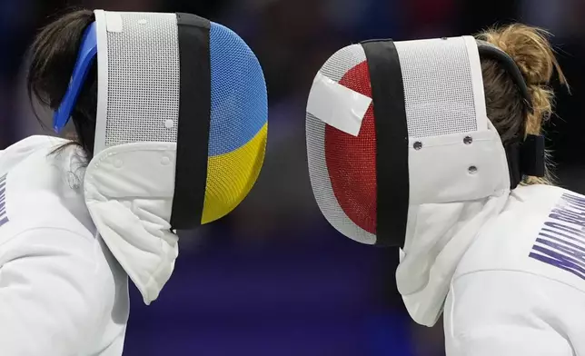 France's Auriane Mallo Breton, right, and Ukraine's Vlada Kharkova compete in the women's individual Epee quarterfinal match during the 2024 Summer Olympics at the Grand Palais, Saturday, July 27, 2024, in Paris, France. (AP Photo/Andrew Medichini)