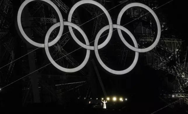 Singer Celine Dion performs from the Eiffel Tower in Paris, France, during the opening ceremony of the 2024 Summer Olympics, Friday, July 26, 2024. (AP Photo/Abbie Parr)