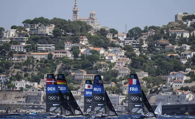 The women's 49erFX skiff class fleet races during practice during the 2024 Summer Olympics, Saturday, July 27, 2024, in Marseille, France. (AP Photo/Carolyn Kaster)