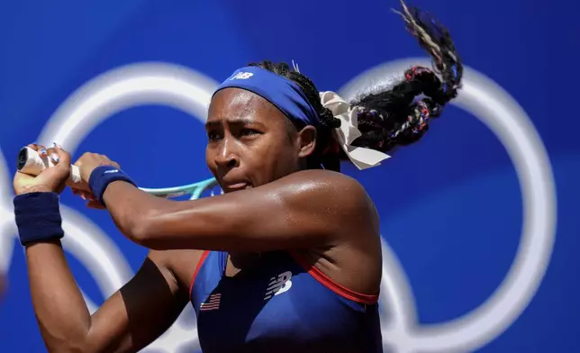 Coco Gauff of the United States returns the ball against Maria Lourdes Carle of Argentina during the women's singles tennis competition at the Roland Garros Stadium at the 2024 Summer Olympics on Monday, July 29, 2024, in Paris, France. (AP Photo/Manu Fernandez)