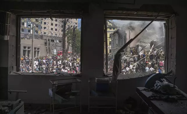 Emergency services work near the site of Okhmatdyt children’s hospital hit by Russian missiles, in Kyiv, Ukraine, Monday, July 8, 2024. Russian missiles have killed at least seven people and struck a children’s hospital in the Ukrainian capital, Kyiv, authorities say. (AP Photo/Evgeniy Maloletka)