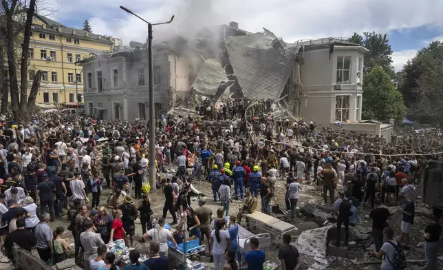 Rescuers and volunteers clean up the rubble and search victims after Russian missile hit the country's main children hospital Okhmadit during massive missile attack on many Ukrainian cities in Kyiv, Ukraine, Monday, July 8, 2024. A major Russian missile attack across Ukraine killed at least 20 people and injured more than 50 on Monday, officials said, with one missile striking a large children’s hospital in the capital, Kyiv, where emergency crews searched rubble for casualties. (AP Photo/Efrem Lukatsky)