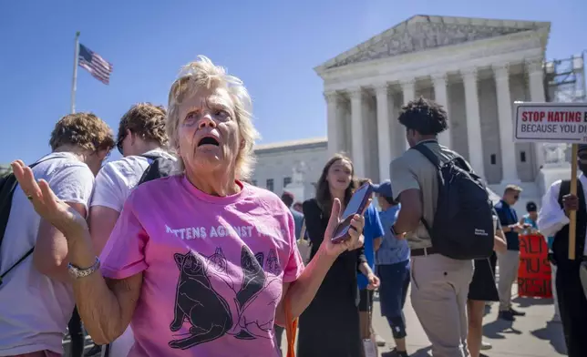 Celeste McCall, of Washington, reacts in confusion, Monday, July 1, 2024, outside the Supreme Court in Washington after decisions were announced. "I'm confused I was told [Trump] has no immunity for unofficial acts," says McCall. "I don't even know what that means. I'm beyond confused." (AP Photo/Jacquelyn Martin)