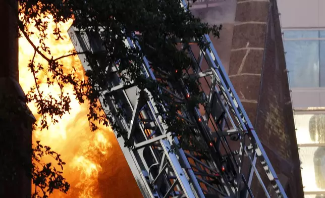 Firefighters battle a fire at First Baptist Dallas church on Friday, July 19, 2024, in Dallas. (Chitose Suzuki/The Dallas Morning News via AP)