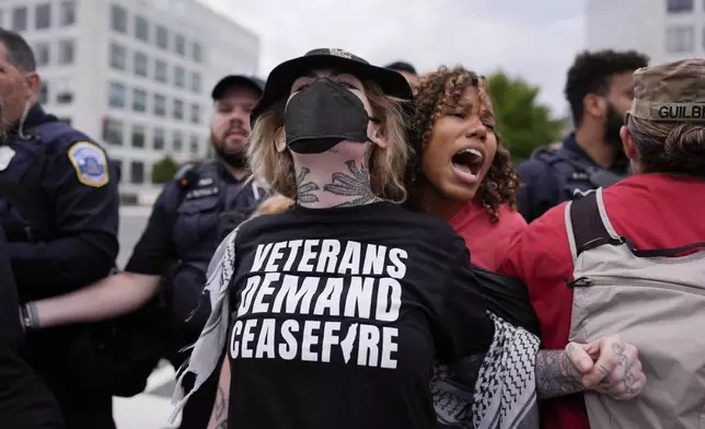 Washington Metropolitan Police clear demonstrators from blocking traffic, Wednesday, July 24, 2024, in Washington, ahead of a scheduled visit by Israeli Prime Minister Benjamin Netanyahu at the U.S. Capitol. (AP Photo/Mike Stewart)