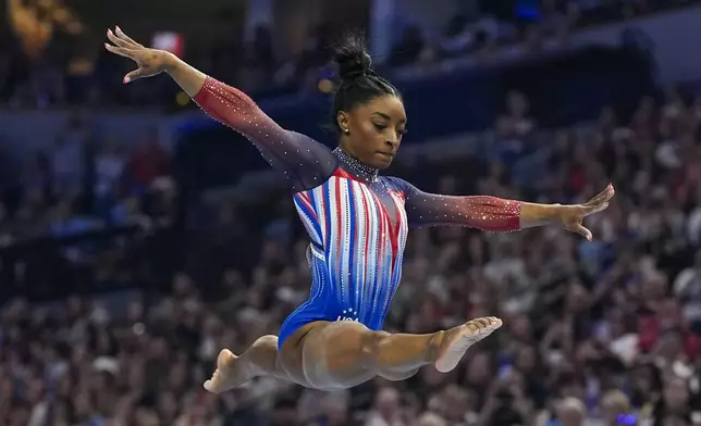 Simone Biles competes on the balance beam at the United States Gymnastics Olympic Trials on Sunday, June 30, 2024, in Minneapolis. (AP Photo/Abbie Parr)